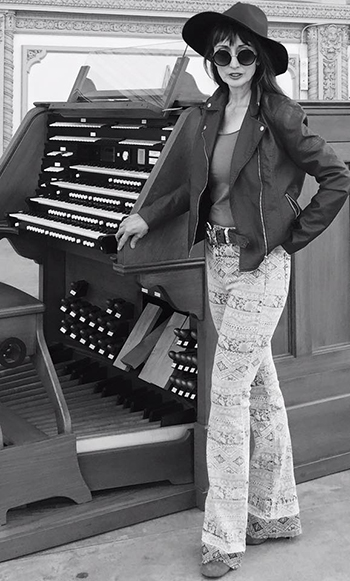 Carol Williams in jazzy pants at an organ console